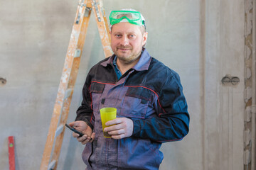 An electrician drinks tea during his lunch break at the enterprise.