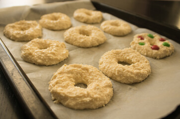 Cottage cheese rings on a baking paper on a baking sheet. Receip for breakfast. Selective focus