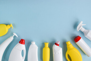 White detergent bottles on a blue background. Clean bottles for detergents and cleaning products....