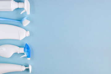 White detergent bottles on a blue background. A copy of the space. empty space. Flat lay