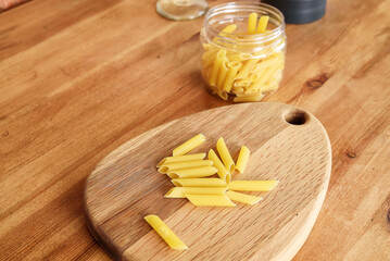 Top view of pasta. raw spilled Italian pasta view from above on neutral background. Repetition concept.
