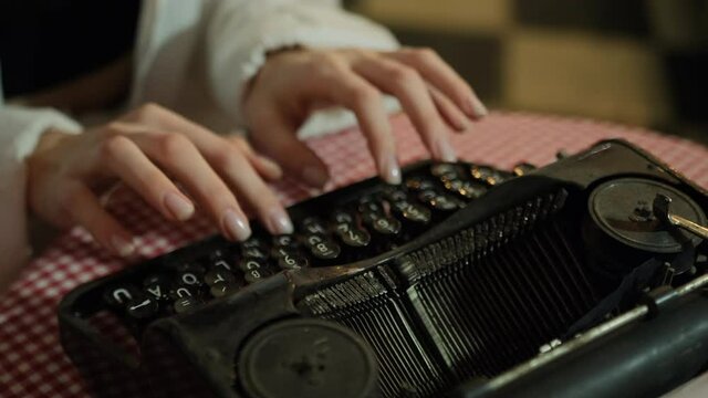 Secretary at old typewriter. Business concepts. Retro. Pensive hands typing