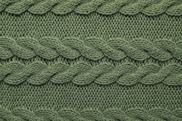 Knitted dark woolen fabric as background, top view