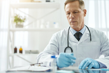 Handsome male doctor working in clinic or healthcare center