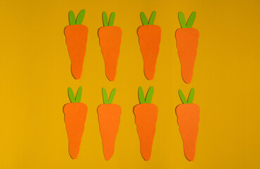 Colorful carrots on yellow background. Carrots pattern on vivid background