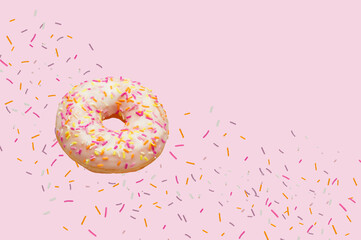 Doughnut  flying in the air along with decorative powder on a pink background.