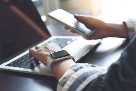 Business woman working on laptop computer and using mobile phone searching the internet. Student studying online class, E-learning concept