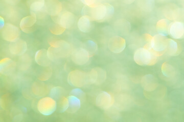 Fototapeta na wymiar bright glitter background: bokeh effect from many colored lights on frozen glass, toning
