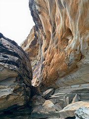 Colorful stone wall on the beach - brown, gray, white