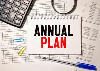 Papers with text, ANNUAL PLAN on table, business concept.