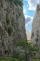 An alpinist climbing a rock in Bulgaria