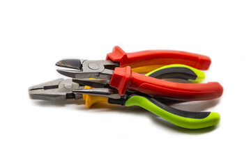 Stack of working electrician hand tools piled in a stack on an isolated background