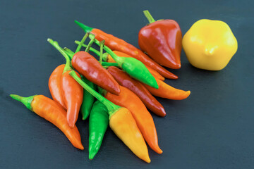 chili pepper red, yellow asia seasoning on black background