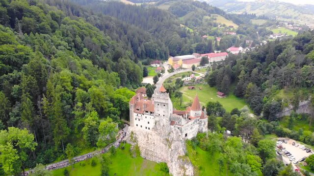 European castle and village old houses with red and orange colored roof. Beautiful historic landmark shot with drone aerial footage 4K 30fps.
