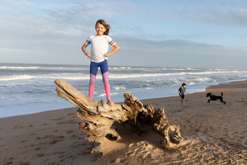 Portrait of young confident girl on the beach at sunset