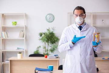 Fototapeta premium Young male doctor virologist in the office
