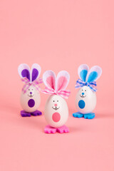 Colorful Easter eggs bunny isolated on pink background