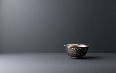 Traditional ceramic bowl on gray background. Soft focus. Copy space.	