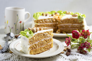 Homemade Carrot Cake with cream cheese frosting on white plate. Selective focus