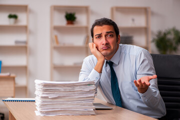 Young male employee unhappy with excessive work