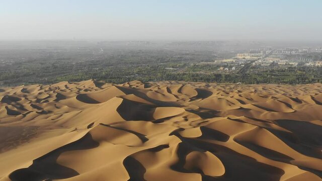 desert landscape at dusk from above, shanshan county kumtag desert, which is the closest desert to the city in the world. xinjiang, China.