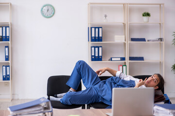 Young male employee sleeping in the office on chairs