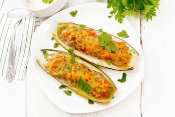 Cucumber stuffed with meat and vegetables on light board top