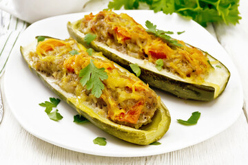 Cucumber stuffed with meat and vegetables on light board
