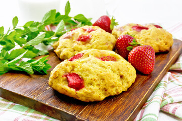 Scones with strawberry on light board