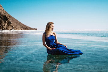 Young beautiful woman in dress on ice