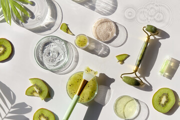 Cosmetic skincare background. Herbal medicine with kiwi slices and palm leaves. Homemade sugar...