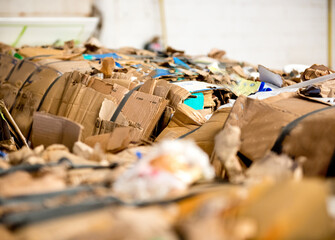 Recycle cardboard packaging concept with stacks of compressed corrugated paper garbage as a symbol to recycle for conservation and environmental technology business.