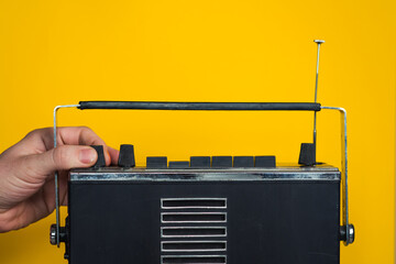 Hands of people controls the volume balance of the old vintage radio turns adjustment audio...