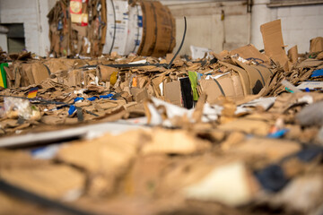 Fototapeta na wymiar Recycle cardboard packaging concept with stacks of compressed corrugated paper garbage as a symbol to recycle for conservation and environmental technology business.