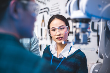 Meeting asian Engineers Maintenance Robot Arm at Lab. they are in a High Tech Research Laboratory...