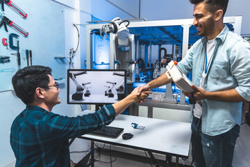 Meeting asian Engineers Maintenance Robot Arm at Lab. they are in a High Tech Research Laboratory with Modern Equipment. Technology and Innovation Concept.