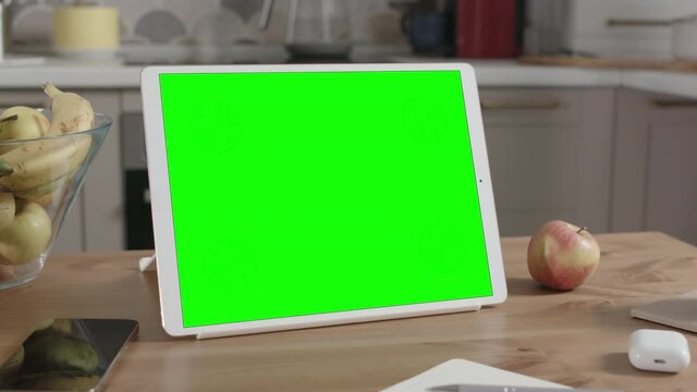 Tablet on Wooden Table in Kitchen Interior