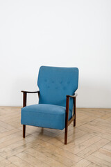 blue armchair in an empty room