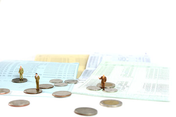 Fototapeta na wymiar Business man standing on stack of coins and saving account passbook.