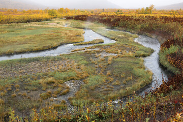 Trekking around volcanoes of Kamchatka in fall season. Northern pristine nature.