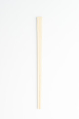 Fototapeta na wymiar Disposable wooden chopsticks on a white background