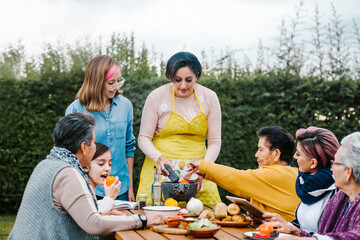 latin mother and daughter cooking together mexican food at home in Mexico city