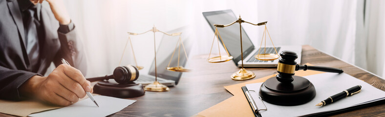 justice and law concept.Male judge in a courtroom on wooden table and Counselor or Male lawyer...