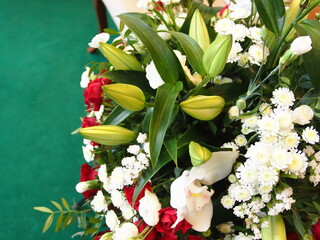 large arrangement of flowers stands on the table