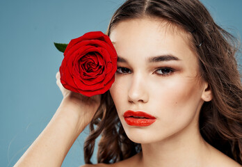 Fototapeta na wymiar Close-up woman portrait red rose cropped view of brunette