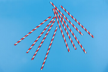 Cocktail tubes lie on a blue background.