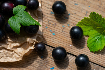 Top view of composition with black berries on wooden table. Freshly picked seasonal berries from countryside garden