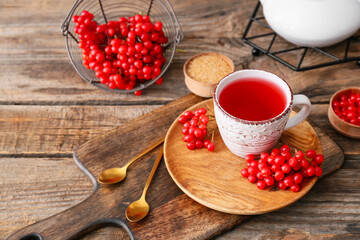 Cup of healthy viburnum tea on table