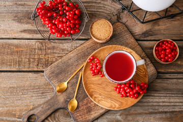 Cup of healthy viburnum tea on table