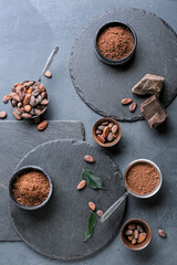 Obraz na płótnie Canvas Cacao powder with beans and chocolate on dark background